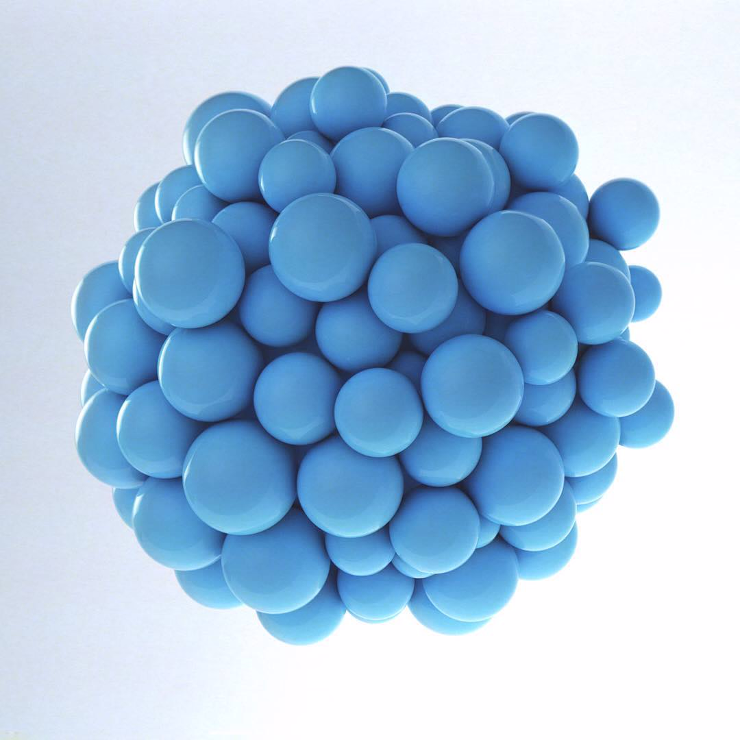 A tight cluster of matte blue spheres against a pale background.